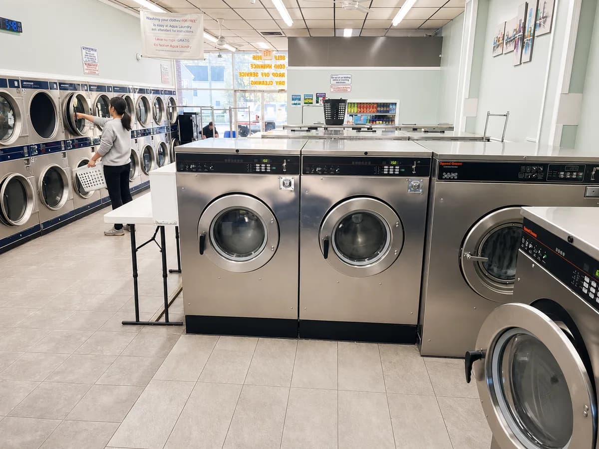 Speed Queen washers and folding tables in the self-service area