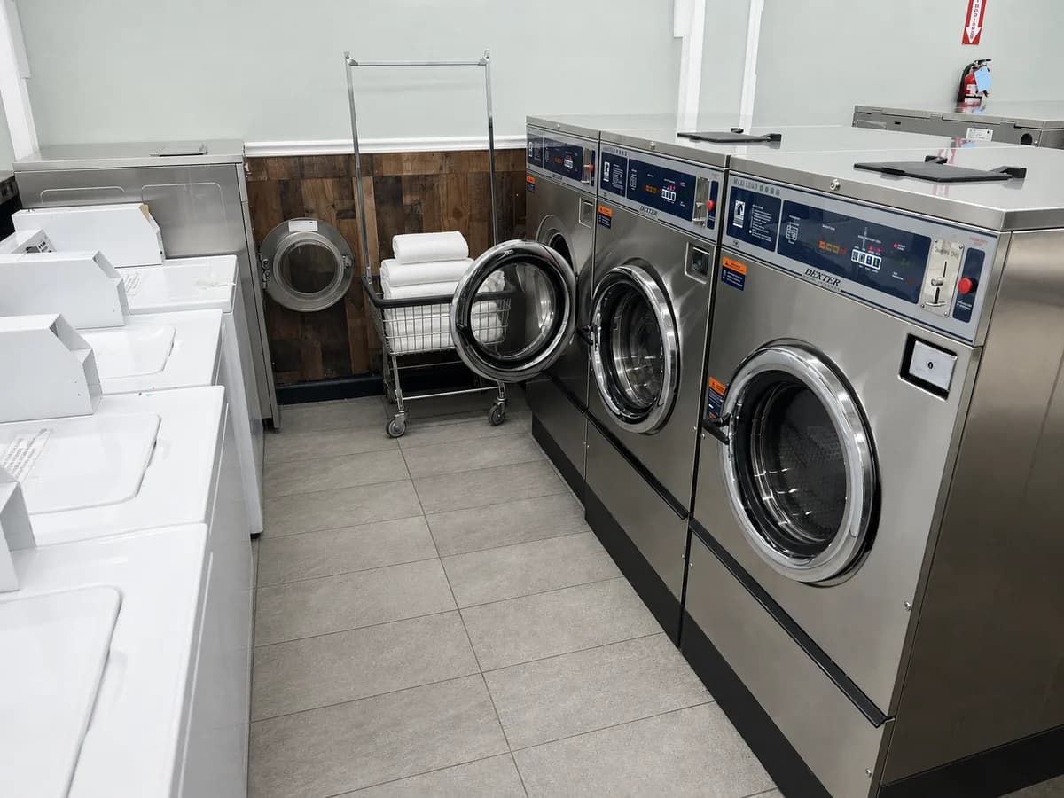 Large-capacity coin-operated washers with a cart of folded towels