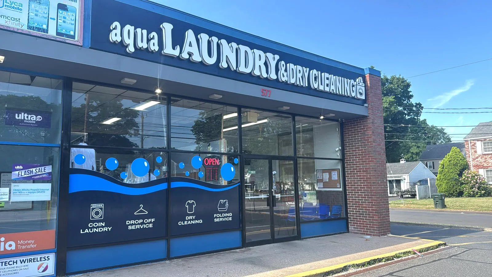 Aqualaundry & Dry Cleaning storefront on Burnside Avenue on a sunny day